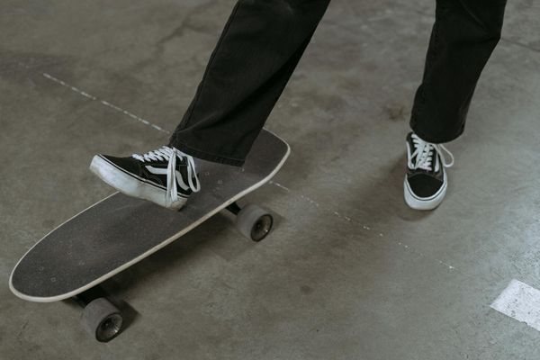 Close-up of feet in a balanced stance on a wooden floor.